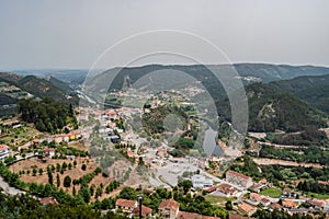 Houses and trees of Penacova in aerial view with Mondego river between mountains, Coimbra PORTUGAL