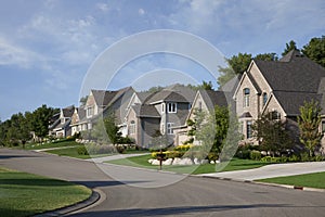 Houses on upscale suburban street in morning sunlight