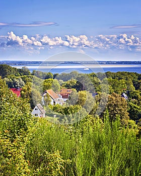 Houses in the valley under the clouds with a view of the Baltic Sea