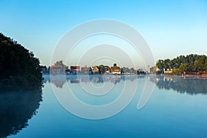 Houses on windless lake "Nieuwe Meer" in Amsterdam.