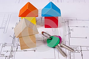 Houses of wooden blocks and keys on construction drawing of house, building house concept