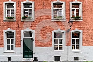 Housewall with multiple windows in a red brickeall