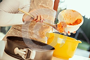 Housewife adds rubbed carrots photo