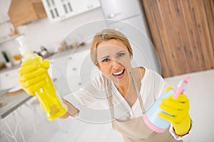 Housewife in apron and gloves looking agitated