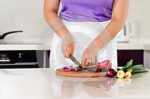 Housewife chopping vegetables in the kitchen