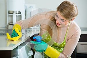 Housewife cleaning in home kitchen