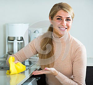 Housewife cleaning in home kitchen