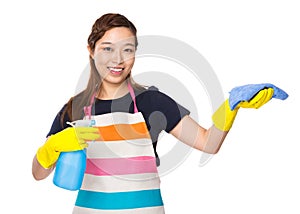 Housewife cleaning with spray and rag