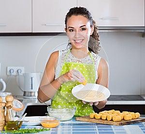 Housewife cooking breadcrumbed croquettes photo