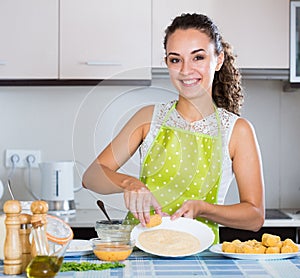 Housewife cooking breadcrumbed croquettes photo