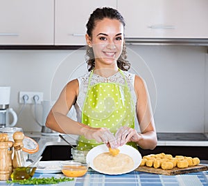 Housewife cooking breadcrumbed croquettes photo