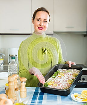 Housewife cooking filleted fish