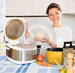 Housewife cooking rice with multicooker