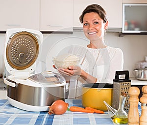 Housewife cooking rice with multicooker