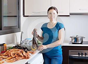Housewife cooking sea food specialties photo