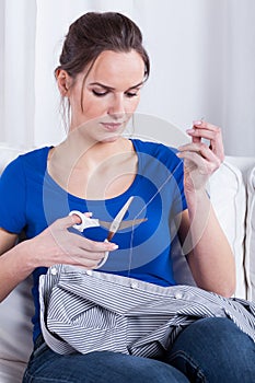 Housewife darning a shirt