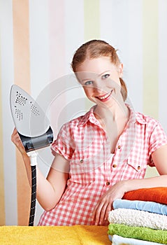 Housewife dreamy woman with iron engaged in domestic work