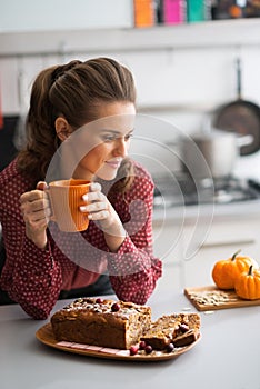 Housewife drinking tea with freshly pumpkin bread