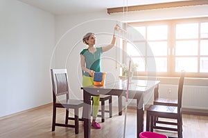 Housewife dusting during spring cleaning