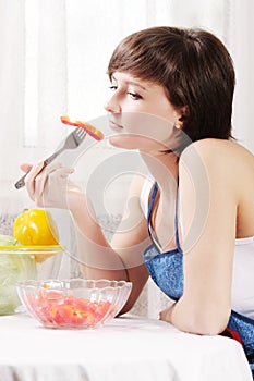 Housewife eating fresh paprika salad