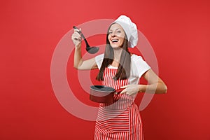 Housewife female chef cook or baker in striped apron white t-shirt toque chefs hat isolated on red wall background