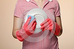 housewife hands with gloves holding scrubberr