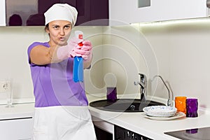 Housewife having fun taking aim with the detergent