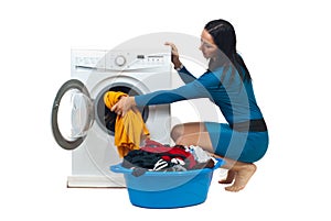 Housewife loading washing machine