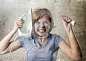 Housewife or maid domestic service woman holding upset an iron strangling her neck photo