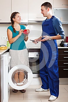 Housewife paying repairman for work