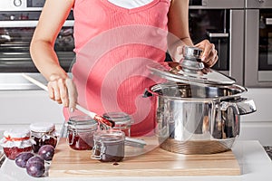 Housewife preparing plum jams