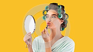 Housewife Putting On Lipstick Holding Mirror Over Yellow Background, Panorama