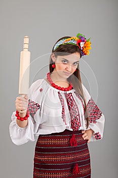 Housewife with rolling pin. Woman wears Ukrainian national dress