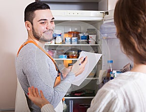 Housewife showing broken refrigerator
