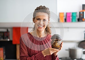 Housewife showing jar of pickled mushrooms