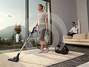 Housewife with vacuum cleaner