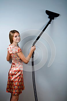 Housewife with vacuum cleaner indoors