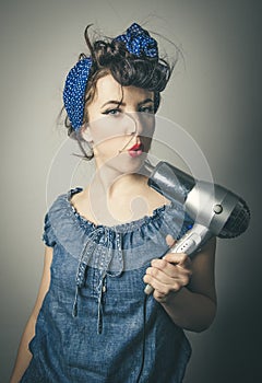 Housewife in vintage clothes with hair dryer