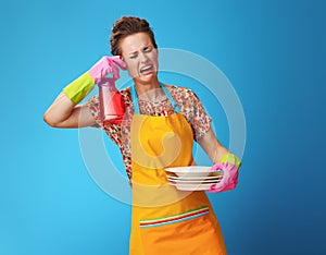 Housewife with washed plates wants to shoot from dish soap