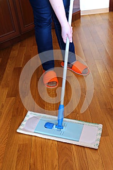 Housewife washes floor of mop