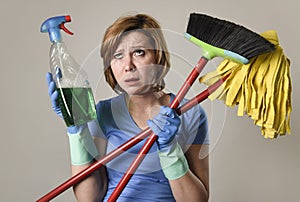 Housewife in washing gloves with cleaning spray bottle broom and