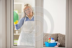 Housewife washing windows photo