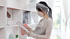 Housewives use towels to wipe things, tables, chairs, display cabinets and glass inside the hous