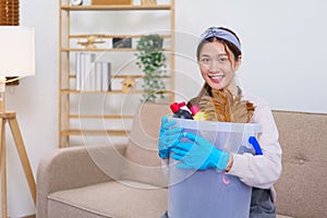 Housework concept, Housemaid is wear glove and hold cleaning supplies to prepare cleanups the house