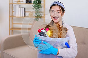 Housework concept, Housemaid is wear glove and hold cleaning supplies to prepare cleanups the house