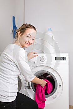 Housework: young woman doing laundry