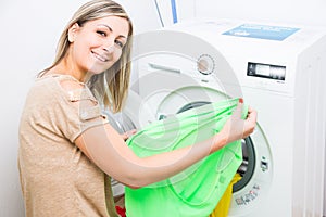 Housework: young woman doing laundry photo