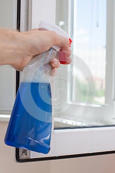 Houseworker clean plastic pvc windows with detergent.