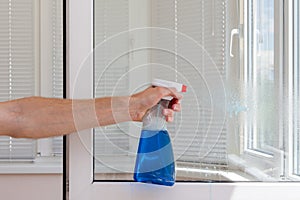 Houseworker clean plastic pvc windows with detergent.