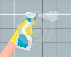 Houseworker clean tiles with spray.